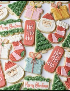 decorated christmas cookies with santa clause, stockings and gifts on them for the holiday season