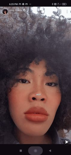 a woman with an afro is looking at the camera