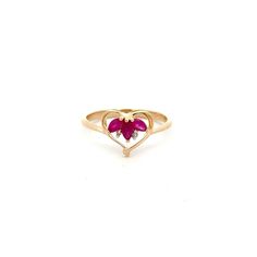 A lady's ruby & diamond ring.  Prong set in the center of the ring in a heart shape are (3) marquise rubies and (2) single cut diamonds. This ring is a size 7.  This ring includes a free sizing up or down 2 sizes.  Once a ring is re-sized, we guarantee the work but we are unable to offer a full refund on the ring. Please contact us for additional sizing options and updated shipping dates if you would like the ring to be sized.   Metal Content Guaranteed 10k yellow gold Weight: 1.9 grams Stone In Oval Heart Ring For Valentine's Day Promise, Oval Heart Promise Ring For Valentine's Day, Red Heart Ring With Center Stone, Red Heart-shaped Diamond Ring, Red Heart-shaped Rings With Center Stone, Heart Cut Ruby Jewelry, Heart-shaped Ruby Jewelry For Wedding, Heart-shaped Gemstone Ring For Valentine's Day, Heart-shaped Ruby Wedding Jewelry