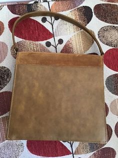 "Vintage 1960's 1970's Brown genuine Suede and Vinyl handbag. The handle is shorter and not able to put on the shoulder. Fully lined. Has an inside slip pocket as well as a zippered side pocket. (I have a pair of matching shoes listed in my shop. Please check if they are still available). *MORE INFORMATION BELOW* CONDITION: I note the inside zippered pocket has a tear in the lining. Difficult to photograph as the pocket is small. I also note a small wear area on the edge of the flap of the purse Brown Rectangular Bag With Lined Interior, Mid-century Satchel Bags For Everyday Use, Mid-century Rectangular Satchel For Everyday Use, Vintage Hobo Shoulder Bag With Detachable Handle, Vintage Shopping Shoulder Bag With Detachable Handle, Vintage Hobo Shoulder Bag For Evening, Vintage Hobo Tote Bag For Evening, Vintage Top Handle Shoulder Bag For Shopping, Vintage Shoulder Bag With Top Carry Handle For Shopping