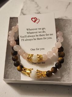 two bracelets on display in a box with a card saying whatever we do you will always be there for me i'll always be there for you