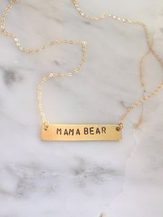 "Personalize this gold bar necklace with any word that has special meaning to you or to a loved one! Give a word of encouragement to someone going through a hard time - \"BRAVE\" Remind her how valuable she is - \"PRICELESS\" Does she light up your day? If so, tell her! - \"SHINE\" Going on a trip? - \"WANDER\" Remind her it's gonna be ok. Keep your chin up - \"HOPE\" ● 16\" chain ● Completely customizable! Just message me! ● Bar measures 40x8mm ● Solid brass bar ● Gold filled chain ● Handmade b Meaningful Everyday Gold Name Necklace, Minimalist Gold Nameplate Bar Necklace, Everyday Rectangular Necklace With Engraved Text, Everyday Rectangular Necklaces With Engraved Text, Everyday Rectangular Engraved Text Necklace, Gold Hand Stamped Name Necklace For Mother's Day, Gold Hand Stamped Name Necklace For Gift, Hand Stamped Gold Necklace For Best Friend, Gold Hand Stamped Name Necklace As Gift