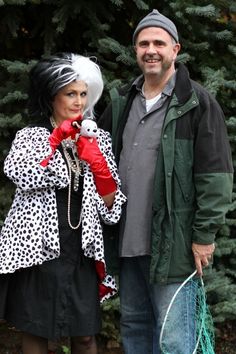 a man standing next to a woman holding a tennis racquet in her hand