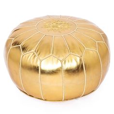 a gold leather poufce on a white background