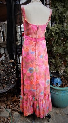 "Lovely Bright 1960's Silk Floral Homemade Sleeveless Pink Full Length Dress XXS This is a stunning vintage pink floral full length dress. I believe the fabric here is silk. It's extremely light weight and airy. There is a full lining here in pink and a long back zipper. It's a swoop neckline with an Empire Waistline with a lovely pink bow at the front. The bottom 11\" of the dress is a ruffle. I see no condition issues here at all. The dress is in amazing condition. It is however quite small so Vintage Sleeveless Party Dress, Fitted Vintage A-line Sleeveless Dress, Retro Sleeveless Lined Dress, Pink Retro Sleeveless Dress, Retro Pink Sleeveless Dress, 1950s Style Sleeveless Lined Vintage Dress, 1950s Sleeveless Vintage Dress, Retro Sleeveless Vintage Dress For Garden Party, Sleeveless Lined Vintage Dress