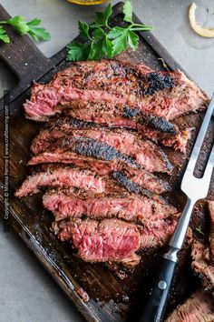 the steak is ready to be grilled on the grill with a knife and fork