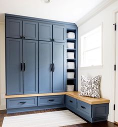 a kitchen with blue cabinets and white dishes