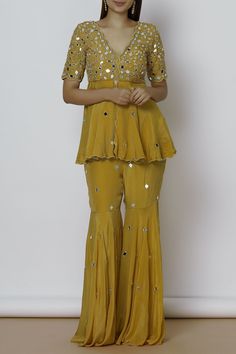 Yellow scallop kurta and sharara with placement mirror work. 
Components: 2
Neckline: V-shaped neckline
Sleeve Length: Half
Fabric: Crepe,Shantoon
Color: Yellow
Mirror embroidery
Kurta with front slow
Closure:
Kurta: Side zip
Sharara: Side hook,zip - Aza Fashions Garara Dress, Bride Fashion Photography, Sharara Designs, Indian Bridesmaid Dresses, Haldi Outfits, Mehndi Dresses, Kurta Sharara Set, Yellow Embroidery, Kurta Sharara