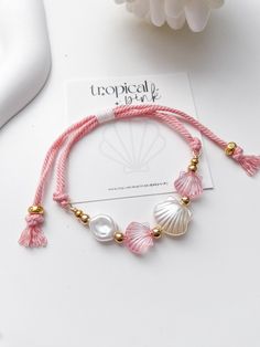 🐚 Shellebrate summer with these beautiful shell bracelets! 😎 All of our bracelets are handmade with high quality materials. The listing is for one bracelet, images showing more than one are an example of how they would look stacked with other bracelets. ITEM DETAILS  🐠 Acrylic clam beads 🐠 Sturdy nylon cord 🐠 Gold plated beads CARE TIPS 🤍 Keep your jewelry dry and away from perfumes or any harsh chemicals 🤍 Store your jewelry separately, and avoid wearing it if you are going to work out. Thank you so much for visiting my shop! 💖 Discover more jewelry by Tropical Pink at: https://www.etsy.com/shop/Tropicalpink Follow me on instagram for behind the scenes: @tropicalpink_jewelry Cheap Adjustable Shell Bracelets, Cheap Pink Pearl Bracelet For Beach, Beach Jewelry Aesthetic, Tropical Bracelets, Bracelet Images, Ocean-inspired Shell Bracelets For Beach Season, Adjustable Shell Beaded Bracelets Ocean-inspired, Adjustable Pink Shell Bracelet, Ocean-inspired Shell Bracelets For Vacation