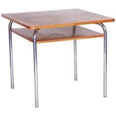 a small wooden table with metal legs