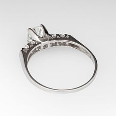 This lovely vintage engagement ring is centered with a round brilliant cut diamond weighing 0.82 carats and set into a four-prong head. The shoulders of the ring are each accented with two (2), prong set, round single cut diamonds. The ring measures 5.8mm at the top, rises 7.1mm above the finger, tapering to 1.3mm wide and 0.6mm thick at the base of the shank. The ring is currently a size 9 and we offer complimentary resizing to fit. Brilliant Cut Diamond Engagement Ring, Vintage Engagement Ring, Emerald Jewelry, Vintage Engagement, Round Brilliant Cut Diamond, Vintage Engagement Rings, High Quality Jewelry, Brilliant Cut Diamond, Diamond Engagement Ring