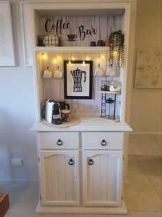 a white hutch with coffee bar lights on it