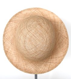 "\"Pina\" is a light summer sun hat with a wide flared brim. The shapely curve of the brim ensures a perfect fit and underlines a clear, feminine look. The material \"Bao\" made of the undyed fibres of the baobab tree is pleasantly permeable to air and ensures maximum wearing comfort. Available in sizes 55 cm - 60 cm. Colour \"nature\" Hat of \"Bao\" - Monkey bread tree Grosgrain ribbon (inside) made of 66% cotton and 34% polyamide Handmade Individualization options Other colours or sizes on req Elegant Boater Hat With Curved Brim In Toquilla Straw, Elegant Sun Hat With Curved Brim In Toquilla Straw, Elegant Toquilla Straw Sun Hat With Curved Brim, Woven Short Brim Boater Hat, Elegant Short Brim Panama Hat For Vacation, Elegant Toquilla Straw Fedora For Spring, Elegant Natural Panama Hat With Curved Brim, Elegant Natural Fedora Hats, Elegant Natural Flat Brim Panama Hat