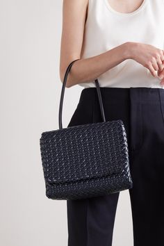 Bottega Veneta's 'Patti' bag is woven from leather in the brand's signature  intrecciato  pattern – each strip is lightly padded for volume. Shown on the Fall '22 runway, it has a compact foldover silhouette free from hardware or emblems. The graceful top handle is long enough to slip comfortably on your shoulder. Luxury Square Woven Leather Shoulder Bag, Luxury Woven Leather Square Shoulder Bag, Chic Business Shoulder Bag With Intrecciato Weave, Classic Top Handle Woven Leather Bag, Formal Rectangular Shoulder Bag With Woven Leather, Formal Rectangular Woven Leather Shoulder Bag, Intrecciato Weave Shoulder Bag For Business, Classic Rectangular Bag With Intrecciato Weave, Designer Top Handle Shoulder Bag With Interwoven Design