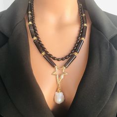 📍 Description :  The handmade multistrand necklace has been designed with Oyx gemstone in black colour and AAA+quality Baroque pearl You can choose this statement necklace for your mom, wife or girlfriend as a gift. 💎 Pendant : AAA+ quality Baroque Pearl 30 mm 💥 The colours of the stone may differ slightly in photo shoots caused by lighting and reflections. The necklace is Modern chunky statement gemstone beaded asymetrical necklace for women. The necklace does not stretch and well kept its s Luxury Gemstone Beaded Necklace For Gift, Multi-strand Gemstone Beads Necklaces For Gift, One Of A Kind Multi-strand Beaded Necklace For Gift, One Of A Kind Multi-strand Beaded Necklace Gift, Luxury Handmade Double Strand Necklace, Spiritual Beaded Necklace With Pearl Pendant As Gift, One-of-a-kind Multi-strand Beaded Necklace For Gifts, Elegant Double Strand Necklaces With Natural Stones, Unique Handmade Double Strand Necklaces