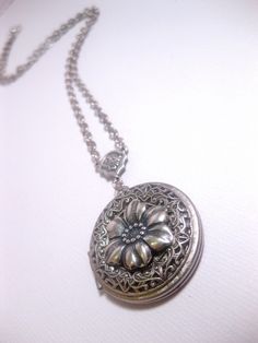 Silver Flower Locket The Locket: - Centered with a real flower in resin dome - Measures 32mm round (1.25 inches round) The connector and locket together hangs down approximately 2 inches from necklace chain. Chain: - Silver Plated - YOU CHOOSE YOUR CHAIN LENGTH FROM DROP DOWN MENU TOOL ☻☻ TO see MORE of our LOCKET NECKLACEs (while supplies last): https://www.etsy.com/shop/FashionCrashJewelry/search?search_query=locket&order=date_desc&view_type=gallery&ref=shop_search ☻ Link To My Ent Vintage Circle Necklace For Gifting, Vintage Circle Necklace For Gifts, Vintage Flower-shaped Nickel-free Necklaces, Silver Flower Locket Necklace, Handmade Adjustable Round Locket Necklace, Silver Flower Locket Jewelry, Elegant Adjustable Round Flower Necklace, Silver Flower-shaped Locket Jewelry, Silver Flower Shaped Locket Jewelry