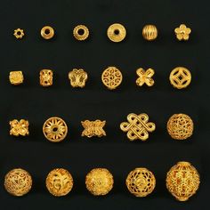 gold jewelry is displayed on a black surface