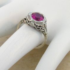 Vintage Estate 2.00 Carat Lab Created Ruby Solitaire Filigree Ring. Floral Designs. 925 Solid Sterling Silver. The Top Of The Ring Measures 3/8 Inches In Length. Set With One 6.5 mm High Quality Lab Created Ruby Stone. Stamped 925. Excellent Condition/Like New. Elegant Wedding Ruby Ring With Diamond Cut, Elegant White Gold Ruby Ring For Anniversary, Vintage Ruby Ring With Filigree For Wedding, Red Filigree Jewelry For Formal Occasions, Formal Red Filigree Jewelry, Formal Art Deco Birthstone Jewelry, Red Art Deco Jewelry For Formal Occasions, Red Art Deco Hallmarked Jewelry, Classic Silver Ruby Ring For Valentine's Day