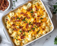 a casserole dish with cheese and bacon on top, surrounded by other dishes