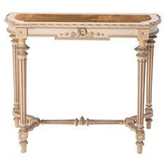 a white and gold console table with an ornate design on the top, holding a wooden tray