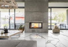 a living room with a fireplace and large windows