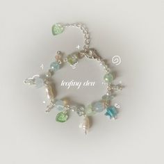 "springtime collection 2/5 *.o - s h o p o p e n i n g - o  o  🌿🌧️ \"leafing dew\" inspired by the rain-laden baby leaves of spring silver plated, lobster clasp, with pearl, fluorite chips, acrylic and glass beads ｡*ﾟ*. o .*o*\"˜ - store carefully in a cool dry place eg. a jewellery box - please keep out of water and other substances to prevent tarnish - handle carefully to prevent breakage - clean with a soft cloth .*o*\"˜ love,  meihuagui \"bringing you the dusty beauty of pressed flowers... Bead Bra, Cat Charm Bracelet, Ethereal Jewelry, Handmade Aesthetic, Manik Manik, O Love, Business Idea, Fancy Jewellery, Boho Gifts