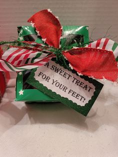 a candy bar wrapped in green and red paper with a tag that says, a sweet treat for your feet