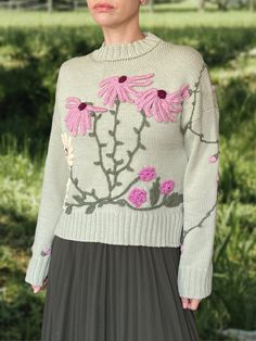 Life is too short to wear boring clothing! This unique embroidered sweater is a one-of-a-kind piece that will truly make you stand out from the crowd. Handcrafted from the highest quality Italian merino yarn, the extremely cosy crewneck features a loose fit and cute 3D decoration in floral motives to create an eye-catching look. DETAILS -Relaxed fit. -Crewneck. -Long sleeve. -Hand-knitted and hand-embroidered. -       Unique, one-of-akind -       Colour: light green Designed and ethically made i Spring Sweater With Multicolor Embroidery And Long Sleeve, Multicolor Embroidered Long Sleeve Spring Sweater, Fall Floral Embroidered Crew Neck Sweater, Fitted Embroidered Crew Neck Sweater, Fitted Cotton Sweater With Floral Embroidery, Fitted Crew Neck Sweater With Floral Embroidery, Fall Sweater With Multicolor Embroidery And Long Sleeves, Fall Long Sleeve Sweater With Multicolor Embroidery, Long Sleeve Sweater With Multicolor Embroidery For Fall