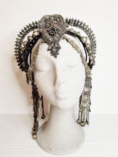 Indulge your inner goddess with this exquisite Afghan tribal headpiece, a bold statement piece that exudes power and elegance. Handcrafted with a mix of intricate beads, embroideries, vintage rhinestones, and luxurious vegan leather, this stunning headpiece is a true work of art. Whether you're heading to a festival, a stage show, or a special performance, this headpiece is designed to make you stand out from the crowd with its captivating glamour and tribal allure. Crafted for comfort and light Adjustable Rhinestone Headpiece For Festival, Adjustable Rhinestone Festival Headpiece, Bohemian Adjustable Tall Crown Headpiece, Adjustable Festival Headpiece With Rhinestones, Adjustable Bohemian Tall Crown Headpiece, Bohemian Handmade Tall Crown Headpiece, Festive Adjustable Crown Headpiece, Adjustable Tall Crown Headpieces For Festivals, Handmade Bohemian Headpiece With Tall Crown