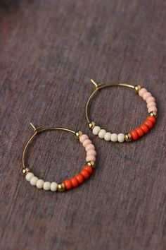 "Lovely beaded earrings with glass seed beads (bright orange,light \"salmon\" and \"ivory\" colors), tiny gold plated metal beads and gold tone stainless steel round hoop earrings. Earring hooks are from nickel free and lead free metal. Perfect jewelry for everyday wear or a great gift for someone special! Diameter of hoops is 25 mm Other earrings of my shop you can see here: https://www.etsy.com/shop/NaTavelli?section_id=13757927 Thanks for visit." Summer Tiny Beads Small Hoop Earrings, Trendy Summer Small Hoop Beaded Earrings, Summer Small Hoop Beaded Earrings, Minimalist Handmade Beaded Hoop Earrings, Orange Beaded Hoop Earrings As A Gift, Orange Hoop Beaded Earrings As Gift, Orange Beaded Hoop Earrings For Gift, Orange Beaded Earrings With Tiny Round Beads, Orange Small Hoop Earrings With Ear Wire