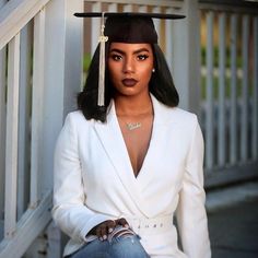 a woman wearing a graduation cap sitting on the steps