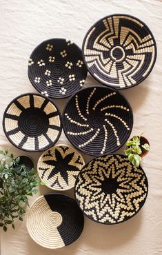 woven baskets hanging on the wall with plants