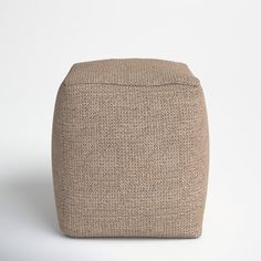 the footstool is made out of fabric and has a small square pattern on it