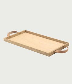 a wooden tray with handles and straps on the bottom, sitting on a white surface