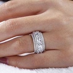 a woman's hand with a diamond ring on it