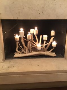 a bunch of candles that are in a fireplace