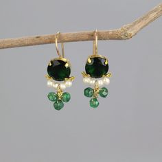 A pair of glowing and dainty clover earrings set with green zircon in copper bezel. Beautiful pearls encircle the lower part of the green zircon, and three striking aventurine gemstones are interwoven gently. This unique earrings design is timeless, so you can enjoy it for years and years to come.  The hook is made of gold filled.  Materials:  Stone: green zircon, pearls, aventurine Metal: gold filled, copper bezel Measurements:  Length including hook: 3cm Width: 15mm Green zircon in diameter: 10mm Since I mostly use natural gemstones, each jewel is unique and therefore there are subtle differences in color and form. Pearl properties: Offers the power of love, money, protection, and luck.  Find more clover earrings here: https://etsy.me/2BSBuLs Click here for more earrings: https://etsy.me Dainty Earrings For Jewelry Making With May Birthstone, Green Dangle Pearl Earrings For Pierced Ears, Green Dainty Dangle Earrings, Dainty Green Dangle Earrings, Green Pearl Drop Earrings For May Birthstone, Single Green Pearl Drop Earrings, Green Gemstone Drop Pearl Earrings, Green Round Pearl Drop Earrings, Green Gemstone Pearl Drop Earrings