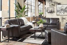 a living room filled with lots of brown furniture