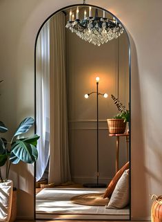 an arched mirror in the corner of a room with potted plants and lights on