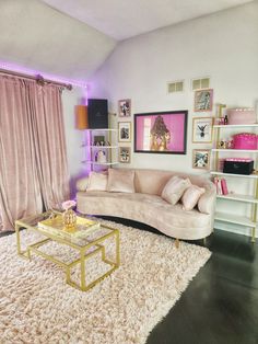 a living room filled with furniture and pink curtains on the window sill, next to a coffee table