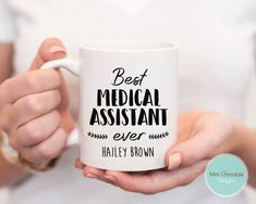 a person holding a coffee mug with the words best dentist ever