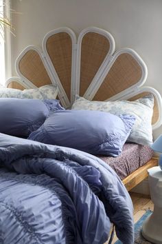 a bed with blue comforters and pillows on it