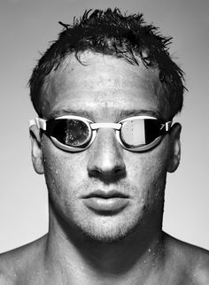 a man wearing mirrored sunglasses and no shirt