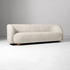 a white couch sitting on top of a gray floor