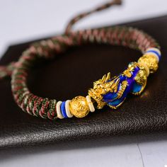 The Pi Xiu bracelet "Wealth and Abundance", carefully hand braided, is adjustable according to the size of your wrist thanks to its sliding thread system. Chic and easy to wear, this 24K gold-plated Pi Xiu protection bracelet will be an original and quality set for your wrist. ABOUT PI XIU This celestial animal is pronounced as “Pixiu” in Chinese. It is a mythical god beast in Chinese mythology, embodied with a dragon head, horse body and qilin’s feet, similar to a lion. Besides that, it has a b Leopard Print Party, Copper Coins, Energy Bracelets, Bangles Bracelets, Mens Beaded Bracelets, Ancient Coins, String Bracelet, Copper Bracelet, Bracelet Clasps