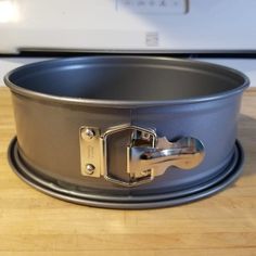 an empty pan sitting on top of a wooden table