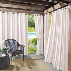 a living room with pink and white striped curtains