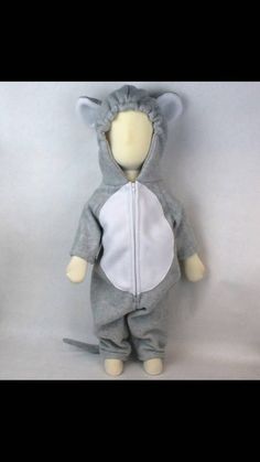 a stuffed animal is wearing a gray and white outfit with ears on it's head