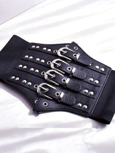 Enhance your edgy and gothic look with this black gothic punk corset belt. Crafted with high-quality materials, this corset belt features a sleek black design with punk-inspired details. Perfect for adding a bold and striking accent to any outfit, this versatile accessory can be paired with a variety of tops and dresses.  Please note that this product includes only the corset belt.  Garment Size   	 		 			Size 			Free Size 		 		 			Width 			12-19 		 		 			Waist 			68-80 Black Punk Belt With Rivets, Punk Black Corset For Cosplay, Gothic Corset With Belt For Cosplay, Black Corset Belt For Concert, Edgy Black Belt Buckle With Removable Belt, Black Fitted Corset Belt For Concert, Gothic Black Corset Belt With Belt Included, Black Punk Corset For Alternative Fashion, Gothic Corset Belt For Party