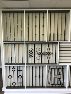 a white bookcase with wrought iron designs on it